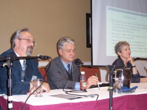 Two Men and a Woman Sitting on the Dias