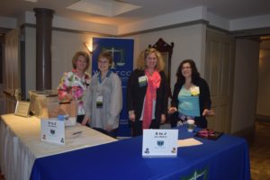 Four Women Standing Behind a Table