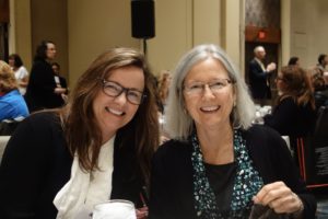 Two Women With Glasses in a Conference