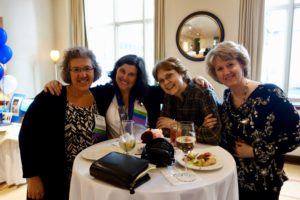 A Group of Women Sitting by a Table