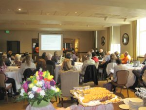 A Group of People Listening to a Presentation