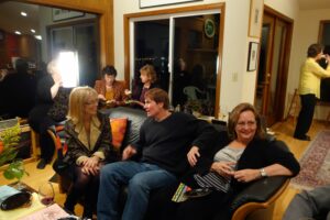 A Group of People Sitting on a Black Color Couch