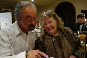 A Man and a Woman Looking at a Phone Screen