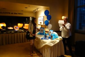 A Woman and a Man Standing by a Table