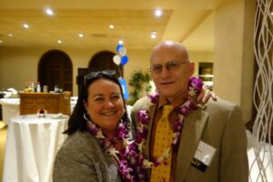 A Man and a Woman Wearing an Orchid Garland