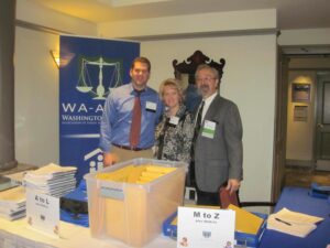 A Woman With Two Men in Front of a Bin