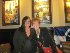 Two Women in Black Smiling at the Camera