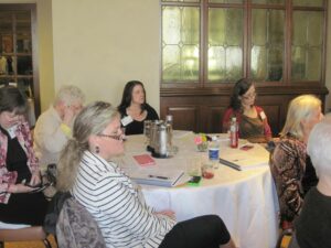 A Group of Woman in Glasses Sitting Around a Table