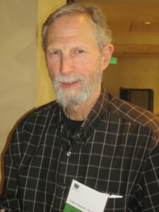 A Man in a Black Shirt and White Beard