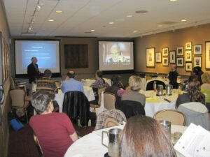 A Man Giving a Presentation on a Projector