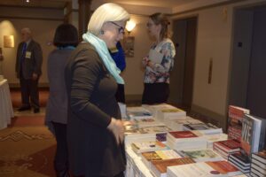 A Woman Looking at Books on a Table