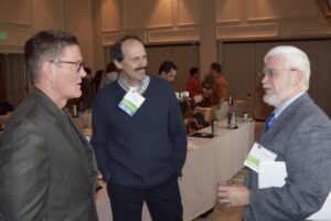 Three Men Talking to Each Other in a Room