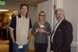 Two Men and a Woman Standing by a Door