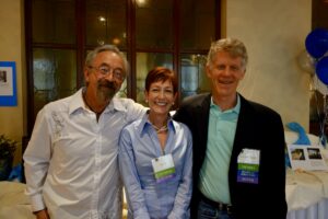 A Woman in a Blue Top Standing With Two Men