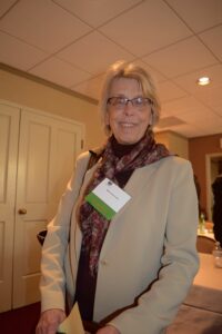 A Woman in a Beige Jacket and a Scarf