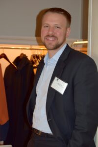 A Man in a Black Color Jacket at an Event