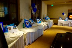 A Table With White Bedsheet and Blue Balloons