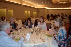 A Group of People Eating by a Table